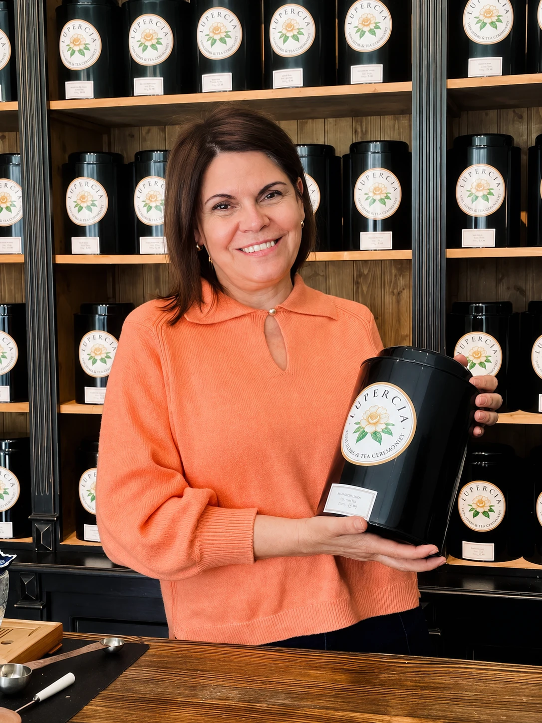 Tee-Sommelière Maria Moreno mit einer Lupercia-Teedose vor ihrem Teeregal